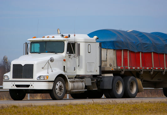 Image of Transportation truck with blue tarpaulin-Supreme Tarps