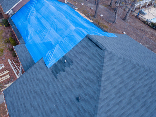 image of Aerial view of roof with blue tarp-Supreme Tarps