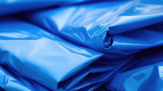 A stack of blue high-quality poly tarps neatly piled up, ready for use.
