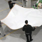 Image of employees give nice finish to four side of Beige 40x40 Tarps-Supreme Tarps