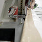 closeup Image of employee give nice finish to the side of 40x40 Beige Tarp with help of machine-Supreme Tarps