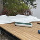 Image of white 40x40 Tarps places on large wooden skid-Supreme Tarps